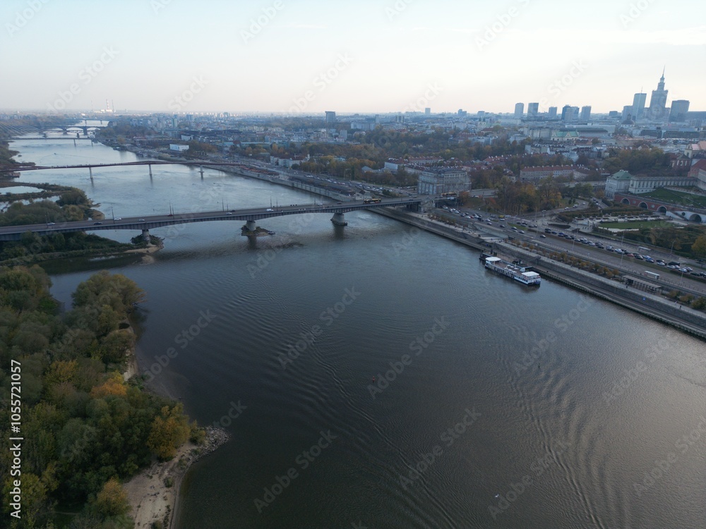 Fototapeta premium Aerial View of River with Bridges in Large City with Skyscrapers on Horizon