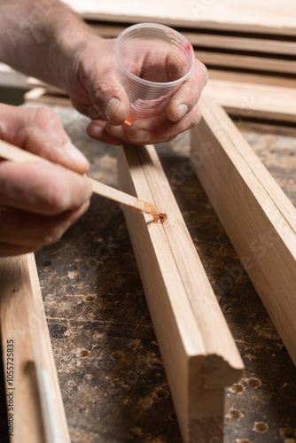 A carpenter restores a chipped board