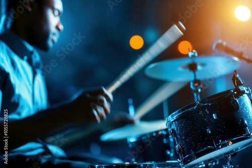 Drummer playing intensively under vibrant stage lights. photo