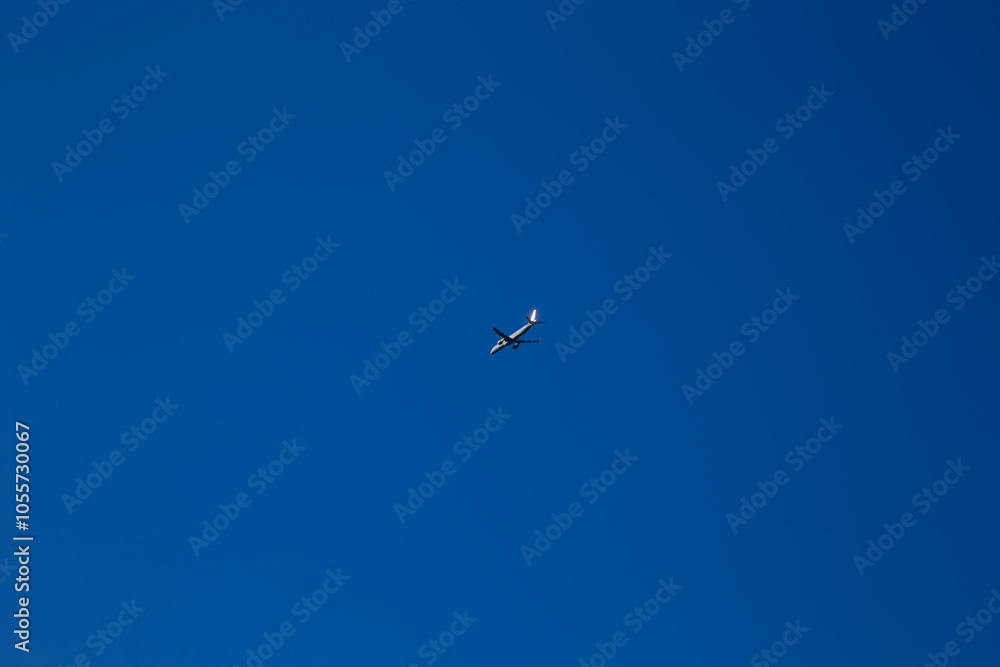 Clear blue daylight sky with an aeroplane in the distance Clear blue daylight sky with an aeroplane in the distance