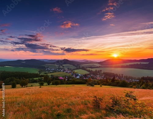 Picturesque sunset in Beskid Sądecki seen from the tower in Wola Krogulecka, with views of the mountains and fields.