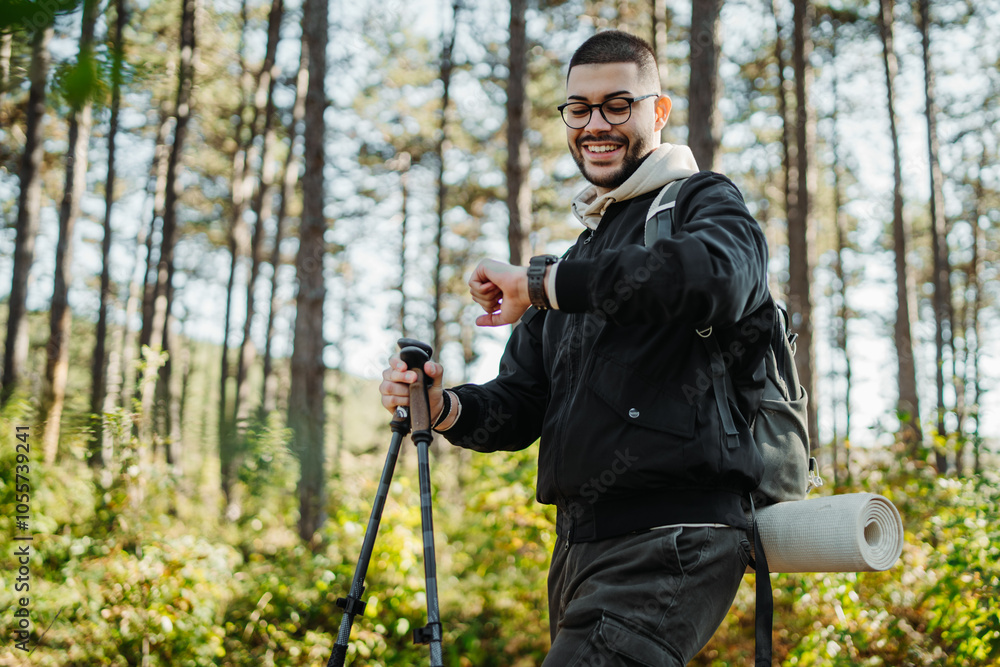 Young caucasian man hiking or trekking through the forest Young caucasian man hiking or trekking through the forest
