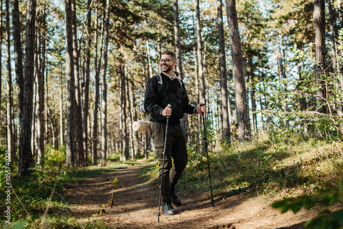 Wallpaper Mural Young caucasian man hiking or trekking through the forest	 Torontodigital.ca