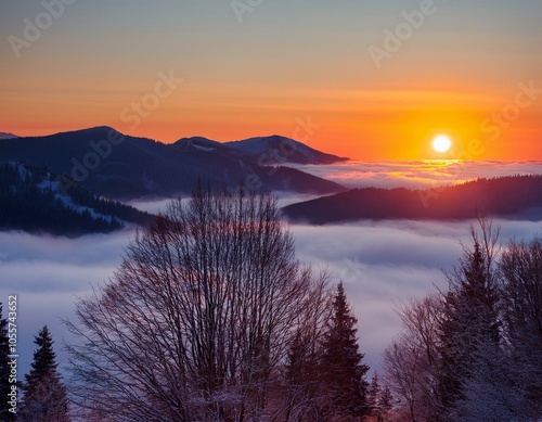 Colorful winter sunrise in the foggy mountains