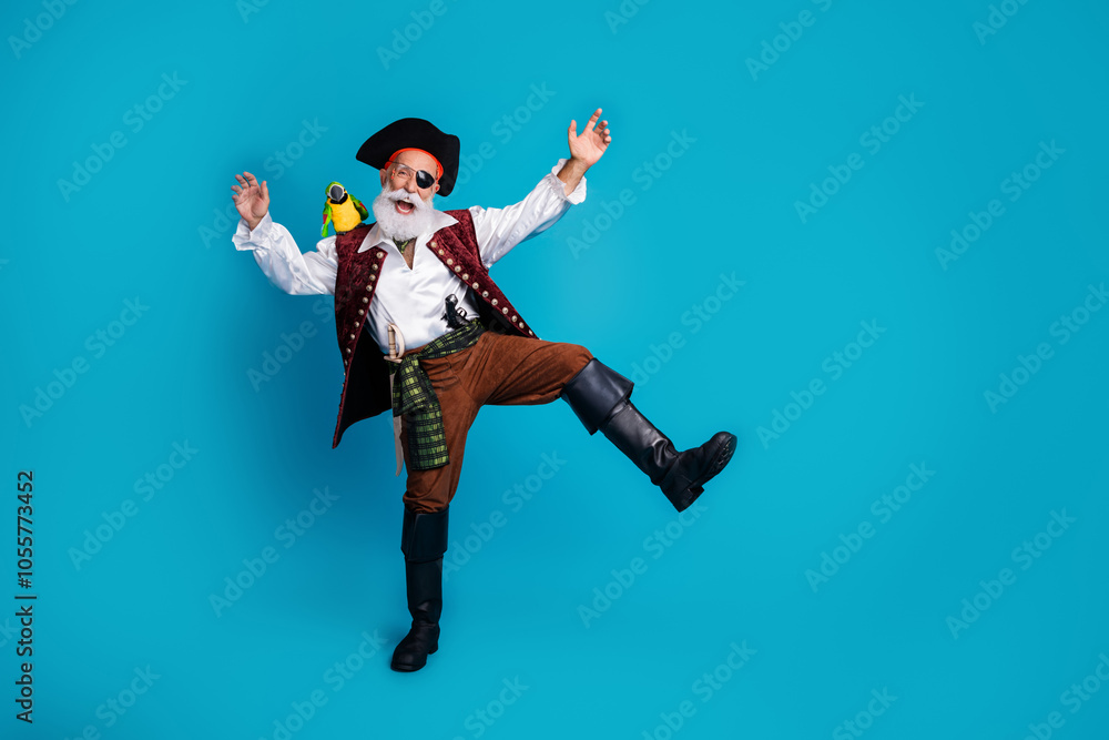 Photo of cheerful buccaneer man dressed pirate costume dancing isolated on blue color background Photo of cheerful buccaneer man dressed pirate costume dancing isolated on blue color background