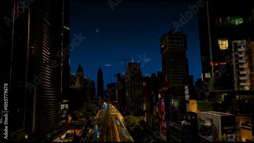 Time-lapse showing a city skyline as it transitions from daylight to glowing nighttime lights, showcasing urban dynamis