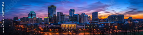 A city skyline at dusk with a large building in the middle