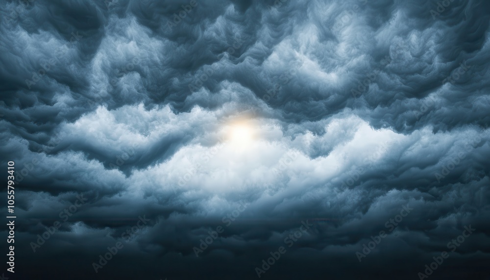 Obraz premium A dramatic sky filled with dark, swirling clouds, illuminated by a soft glow, creating a moody and atmospheric scene.