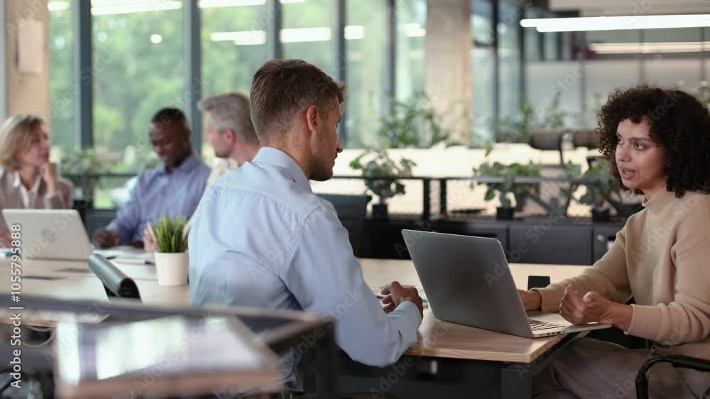 Diverse business team discussing strategy in modern office meeting Diverse business team discussing strategy in modern office meeting