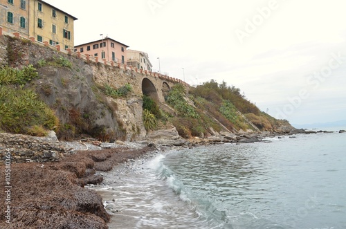 Rocky seashore with buildings on top.