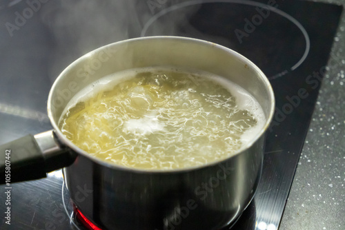 Boiling water on the kitchen stove. Cooking food in the kitchen