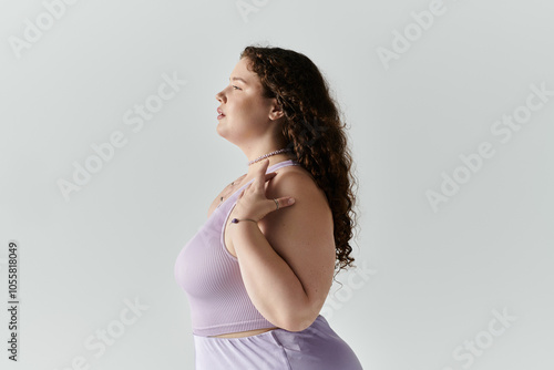 A confident plus size woman showcases her beauty in a soft, elegant pose that inspires self love. photo