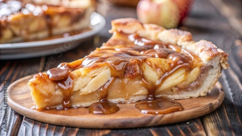 Macro shot of caramel flowing over a slice of apple pie on a wooden board