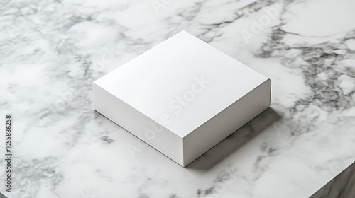 Square box mockup on a marble countertop, with blank surface ready for branding and elegant packaging design