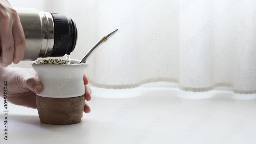 Two argentinians sharing a traditional infusion called yerba mate, lit by natural light. A typical social drink in South America. Two argentinians sharing a traditional infusion called yerba mate, lit by natural light. A typical social drink in South America.