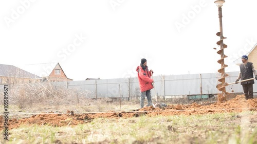 April 2020, Orenburg, Russia. Migrants engaged, guest worker in seasonal construction work. Drilling water wells. Technique for water extraction.