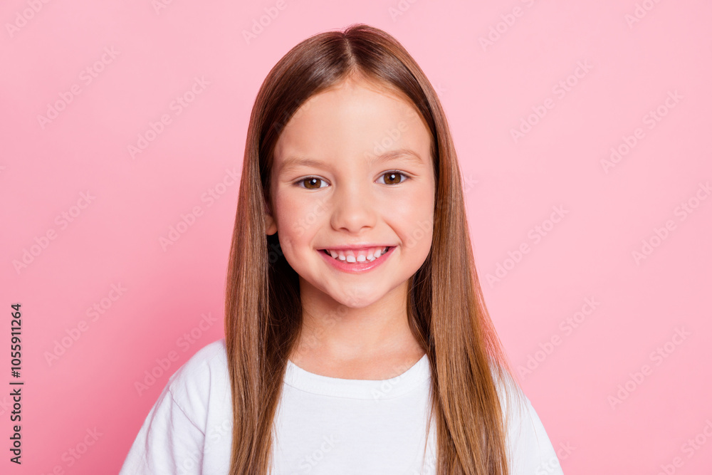 Portrait of charming cheerful little long-haired girl wearing white tshirt isolated over pink pastel color background Portrait of charming cheerful little long-haired girl wearing white tshirt isolated over pink pastel color background
