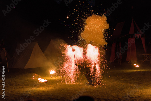 a man in a costume performs a fire show