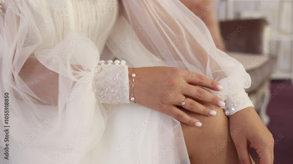 bride's hand with a wedding ring on a wedding dress bride's hand with a wedding ring on a wedding dress