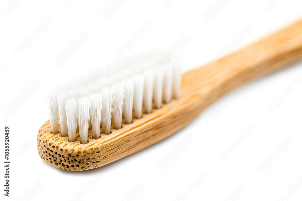 Close-up to an eco-friendly bamboo toothbrush isolated on white background Close-up to an eco-friendly bamboo toothbrush isolated on white background