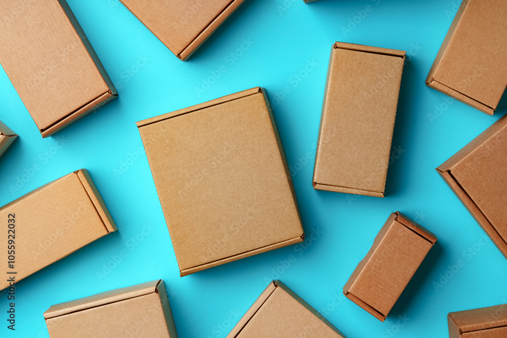 Fototapeta premium A collection of cardboard boxes arranged on a bright blue surface