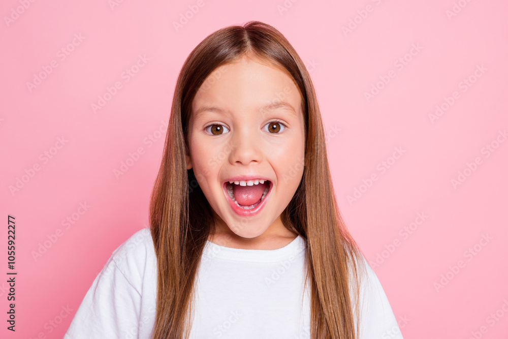 Portrait of attractive cheerful amazed little long-haired girl good news reaction isolated over pink pastel color background Portrait of attractive cheerful amazed little long-haired girl good news reaction isolated over pink pastel color background
