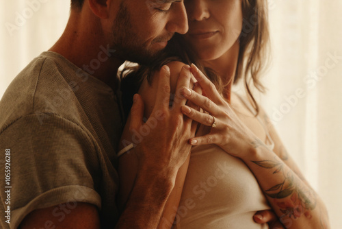 Tender embrace of a couple expecting a baby photo