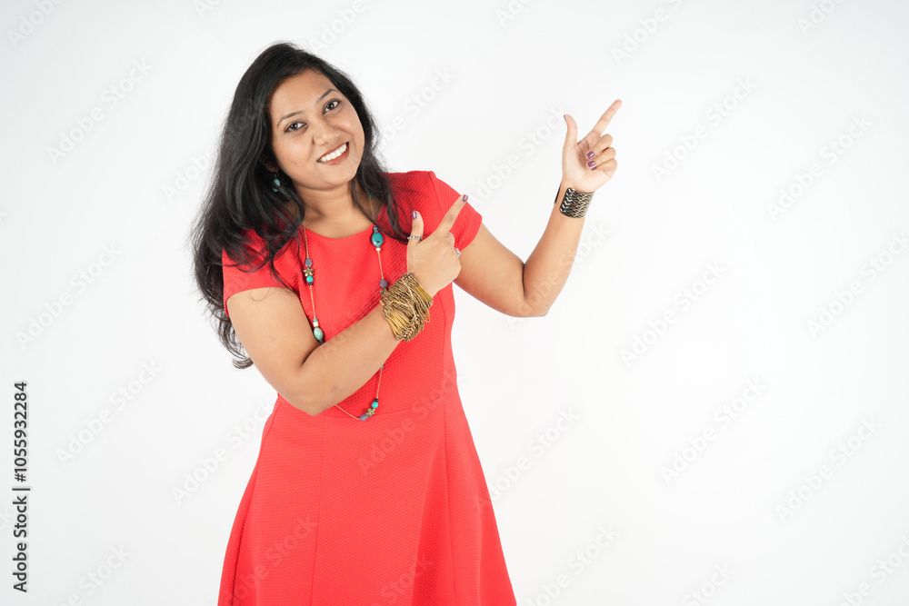 the girl showing advertisement pointing up finger, wear red sexy dress, happy face, isolated over white background. the girl showing advertisement pointing up finger, wear red sexy dress, happy face, isolated over white background.