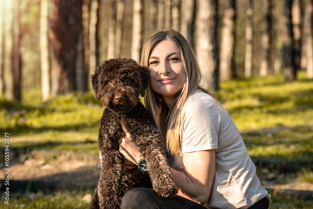 Attractive young woman playing with brown dog in park. Beautiful girl holding puppy in woods and look in camera. Animal lover. Best friends lifestyle concept. Attractive young woman playing with brown dog in park. Beautiful girl holding puppy in woods and look in camera. Animal lover. Best friends lifestyle concept.