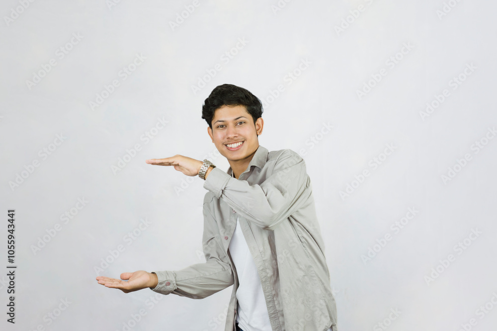 Young Teenager in shirt and vest gives expression of happiness and sadness points with gestures with hands Young Teenager in shirt and vest gives expression of happiness and sadness points with gestures with hands
