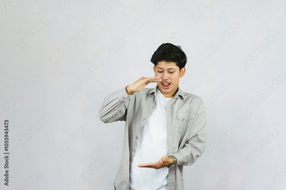 Young Teenager in shirt and vest gives expression of happiness and sadness points with gestures with hands Young Teenager in shirt and vest gives expression of happiness and sadness points with gestures with hands