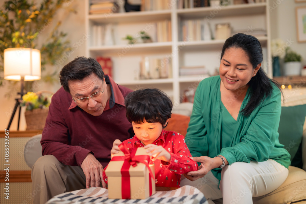 A joyful family moment as child excitedly opens gift with help of grandparents. warm atmosphere highlights love and togetherness during special occasion A joyful family moment as child excitedly opens gift with help of grandparents. warm atmosphere highlights love and togetherness during special occasion