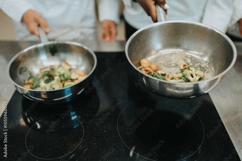Cropped of chefs preparing food in saucepan Cropped of chefs preparing food in saucepan