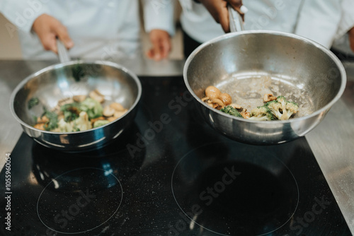 Cropped of chefs preparing food in saucepan photo