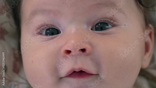 Close-up of baby face showing curiosity and softness, baby looking directly with big eyes, baby’s delicate features in focus, calm and relaxed expression, baby gazing gently