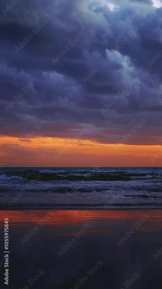 Vertical shot of dramatic sunset sky above sea and peaceful beach Vertical shot of dramatic sunset sky above sea and peaceful beach
