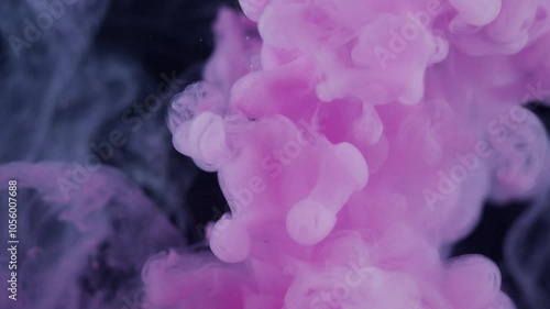 purple and pink ink in water on a dark background