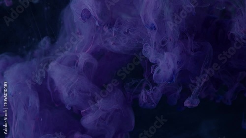 dark purple ink in water against a black background