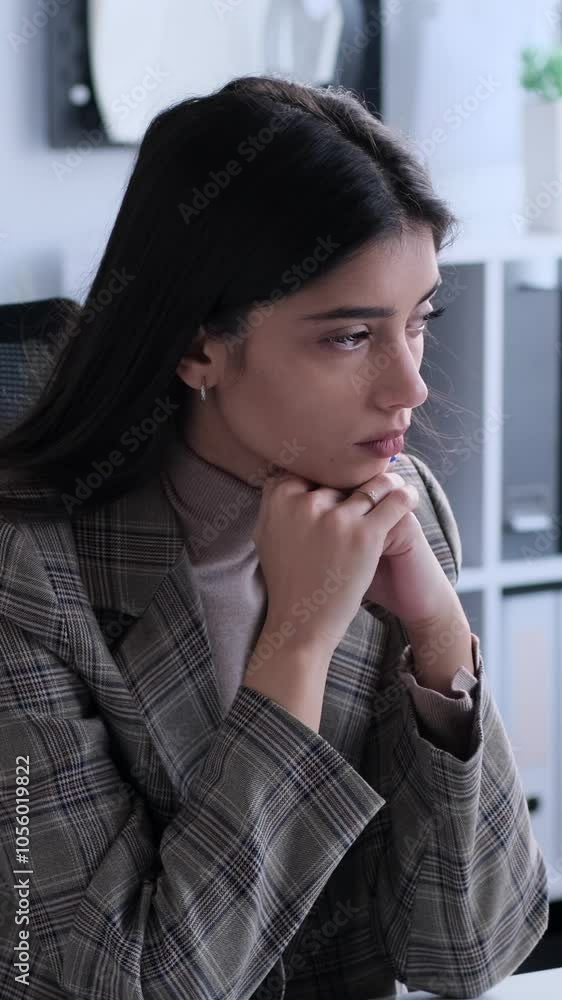 Puzzled Caucasian young adult businesswoman lost in thoughts while working in the office. Concept of a analysis, brainstorming and planning. Vertical video. Puzzled Caucasian young adult businesswoman lost in thoughts while working in the office. Concept of a analysis, brainstorming and planning. Vertical video.