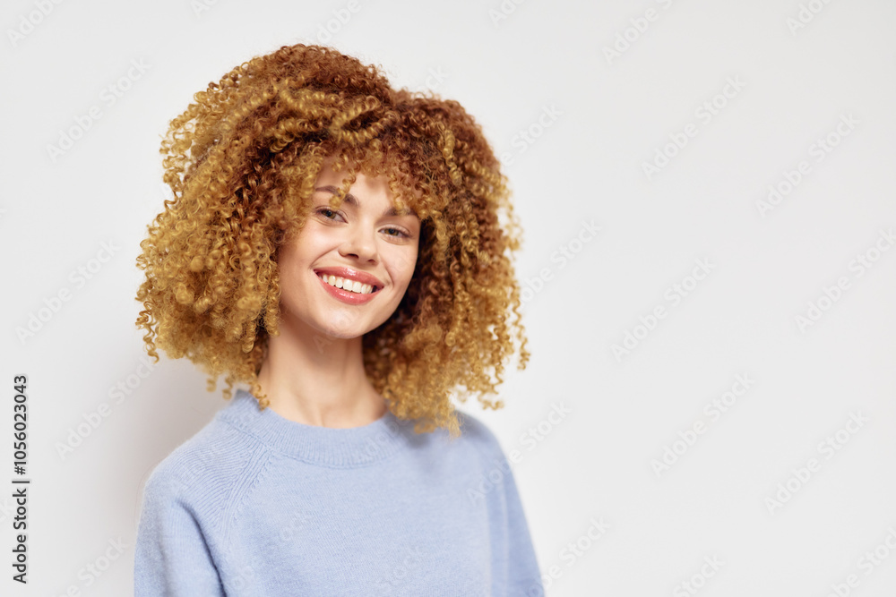 Smiling woman with curly hair in soft blue sweater, light background, natural beauty, friendly expression, lifestyle concept Cheerful mood and positive vibes captured Smiling woman with curly hair in soft blue sweater, light background, natural beauty, friendly expression, lifestyle concept Cheerful mood and positive vibes captured