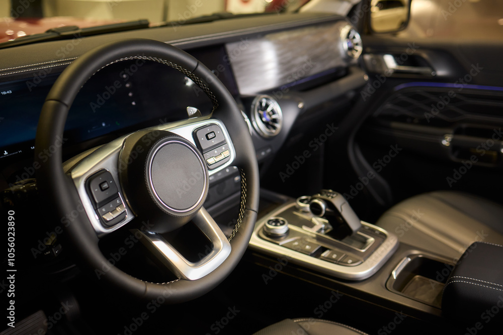 Closeup of a modern car steering wheel with control buttons for technology and convenience Closeup of a modern car steering wheel with control buttons for technology and convenience