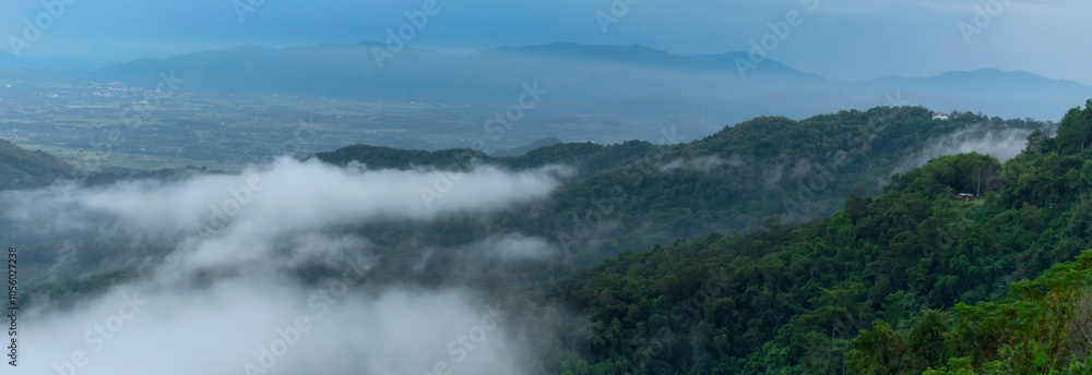 Obraz premium Banner Beautiful Mountain landscape foggy mountain green landscape morning sunrise. Amazing Landscape mountain green tropical forest tree on sunrise. Banner forest sunlight scenery with copy space