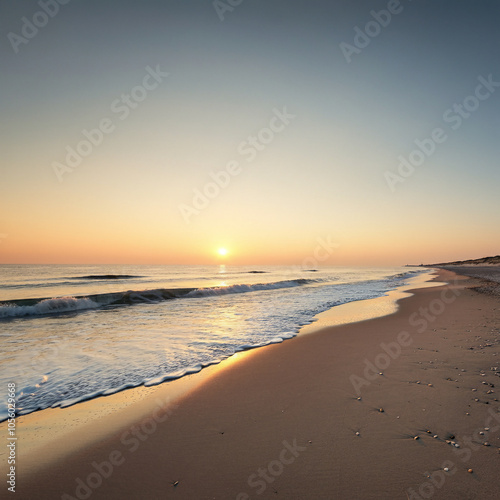 the beach and a calm vast sea the sun shines from the horizon