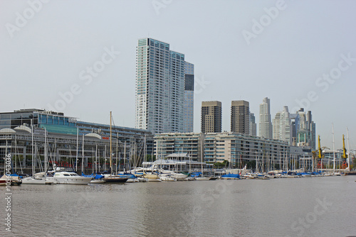 The boats standing in the harbor of Buenos Aires with skyscrapers in the background