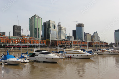 The boats standing in the harbor of Buenos Aires with skyscrapers in the background
