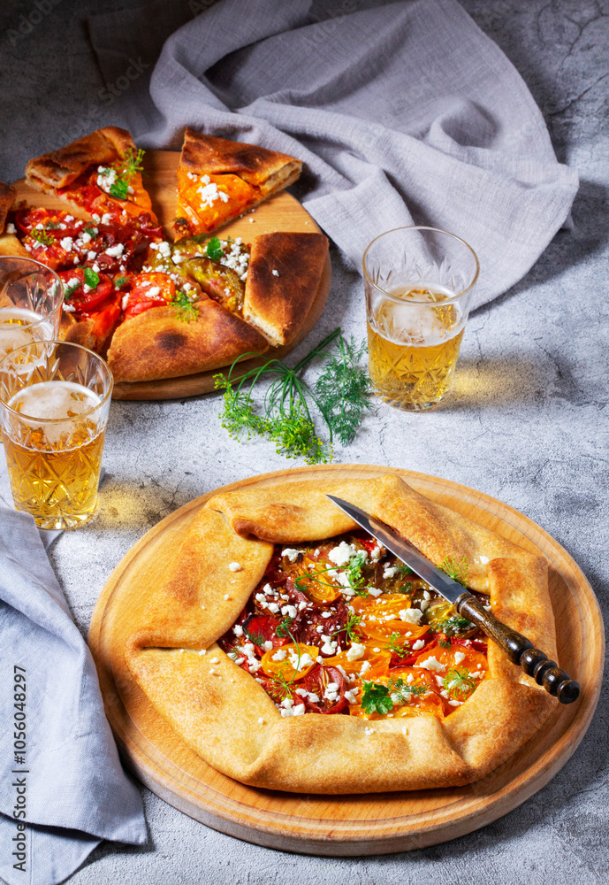 Traditional open pie galette with tomatoes, cheese and herbs, served with beer or wine.