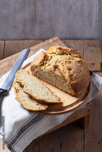 Obraz na płótnie Homemade Irish soda bread cut into pieces and knife on wooden background. w salonie