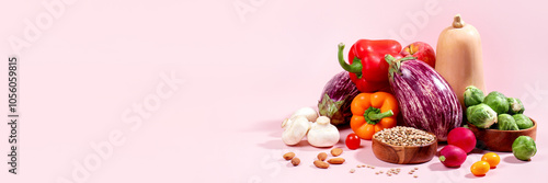 Vegan background with fresh seasonal autumn vegetables, vegan fall still life on pink