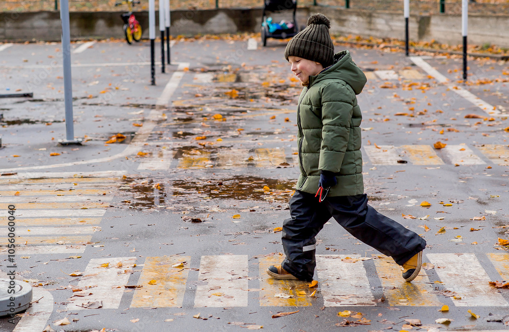 A little boy of 5 years old crosses the street at a pedestrian crossing. Traffic Laws. Be careful-children. A little boy of 5 years old crosses the street at a pedestrian crossing. Traffic Laws. Be careful-children.