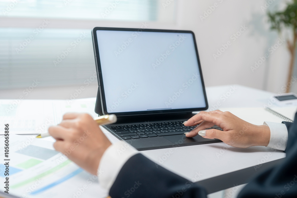 A person is typing on a laptop with a blank screen A person is typing on a laptop with a blank screen